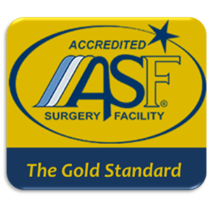 A rectangular badge with a yellow and blue background displaying the logo for an Accredited Surgery Facility. The acronym "ASF" is prominently featured along with the text "Accredited Surgery Facility" and "The Gold Standard" at the bottom.